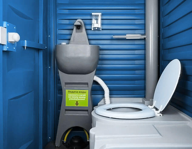 Накопительный бак для отходов и умывальник с ножной помпой, установленые внутри синей туалетной кабины «Люкс».